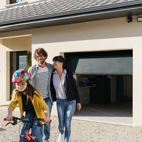 family biking in front of somfy garage door